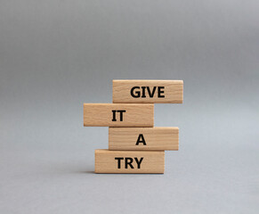 Give it a try symbol. Concept words Give it a try on wooden blocks. Beautiful grey background. Business and Give it a try concept. Copy space.
