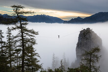 Side View Of Person Walking On High Line In Clouds Above Traunsee Lake, Upper Austria, Austria
