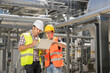 © Cavan Images - Engineer with his colleague in meeting with laptop at geothermal power station, Bavaria, Germany
