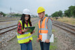 © reewungjunerr - Two engineer working at train station,Work together happily,Help each other analyze the problem,Consult about development guidelines