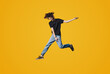 © Strelciuc - Full length photo of young handsome man jumping high up rejoicing celebrating success isolated yellow color background