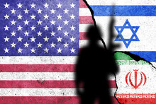 Flags Of United States Of America, Israel And Iran Painted On The Concrete Wall With Soldier Shadow.