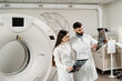 © Rabizo Anatolii - CT x-ray examination of lung cancer in medical clinic. Colleagues doctors with x-ray of computed tomography scanning discussing diagnose of lung cancer in medical clinic.