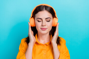 Poster - Photo of sweet shiny woman dressed orange shirt closed eyes enjoying music headphones isolated teal color background