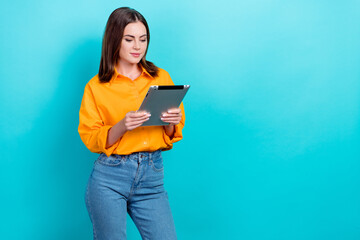 Poster - Photo of intelligent clever girlish woman straight hairdo dressed yellow shirt hold tablet read post isolated on teal color background