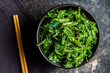 Green seaweed. Japanese wakame salad in bowl. Top view.