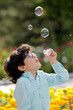 © Fatih - Happy boy playing with colorful umbrella, toy truck in the park