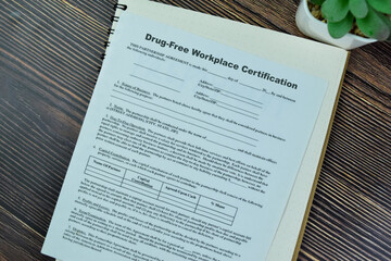 Wall Mural - Concept of SBA Form Drug-Free Workplace Certification isolated on Wooden Table.