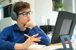 © Cavan Images - Student boy with tablet computer learning at home