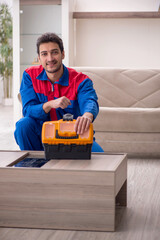 Wall Mural - Young male carpenter working at home