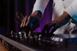 © Volodymyr - hands control the remote control. setting the remote control knob. electronic device of the mixer console.