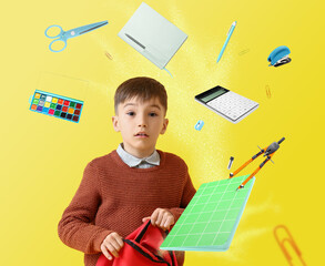 Little boy with backpack and flying school supplies on yellow background