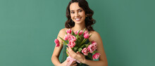 Smiling Young Woman With Tulip Flowers On Green Background