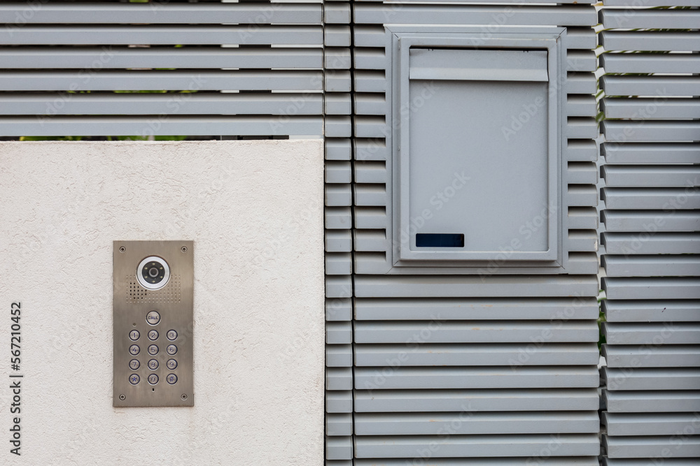 Modern fence with intercom outdoors