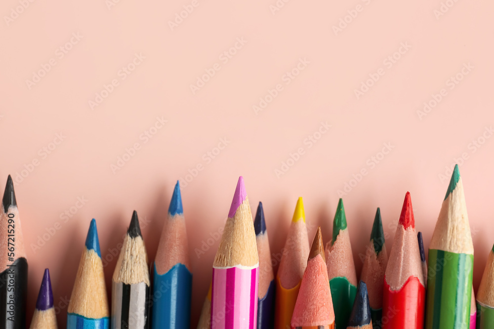 Set of colorful pencils on pink table, top view