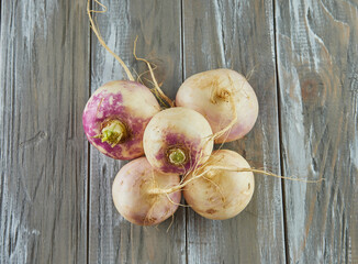 Canvas Print - Fresh purple turnip stacked on wooden gray background