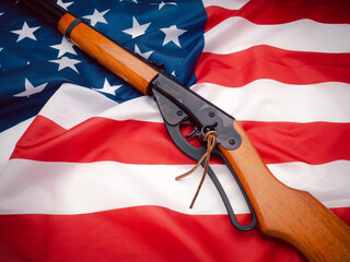 Wall Mural - Top view of a shotgun on the American flag