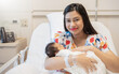 Closeup portrait of young asian Indian hispanic mother day holding newborn baby with copy space. Healthcare and medical daycare nursery love lifestyle together single mom mother’s day holiday concept