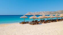 Mykonos Beach During Summer With Umbrella And Luxury Beach Chairs Beds, Blue Ocean At Elia Beach