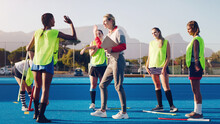 Hockey, Women Team With Coach And Sport, High Five And Coaching With Game Strategy, Training And Fitness On Turf Outdoor. Athlete Stretching, Start Practice And Wellness, Motivation And Support