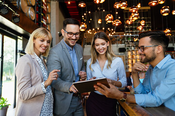 Group of happy multiethnic successful business people having fun, work and meeting in cafe.