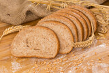 Fototapeta Kuchnia - Sliced bread with bran among ears, wheat grain and flour