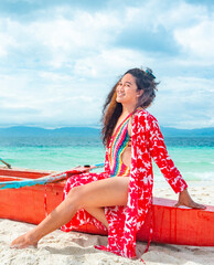 Transgender woman posing in colorful swimwear,on a boat,White Beach,Moalboal,Cebu Island,Philippines.