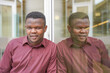 © Sheila - portrait of an african man in a suit. executive outside the office looking at camera and his reflection