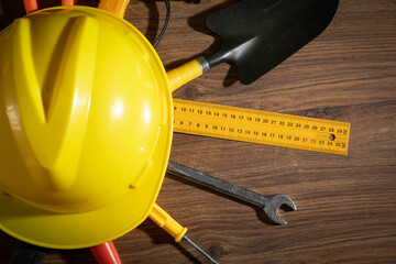 Wall Mural - Work tools with helmet on wooden background.