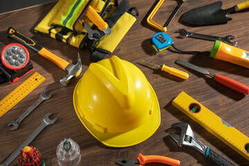 Wall Mural - Work tools with helmet on wooden background.