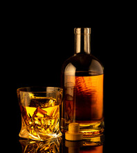 Golden Alcoholic Drink In Decanter, Bottle And Glass