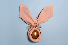 Easter Bunny Egg. Golden Egg Decoration As Rabbit. Bunny Ears. Happy Easter Concept. Pastel Blue Background.