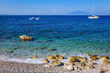 Wall Mural - Capri beach and coastline with boats and sailboats, amalfi coast, Italy