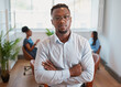 © Meeko Media - Portrait of serious Black businessman, CEO, manager folding arms with colleagues