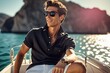 Elegant wealthy attractive male on a yacht on a luxury vacation on the Mediterranean coast of Italy