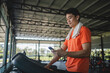© tuiphotoengineer - young male playing phone and listening to music after exercise with various exercise equipment in fitness.