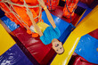 © AS Photo Family - Happy kids playing at indoor play center playground,  boy climbs the ropes.
