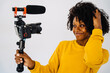 © ADDICTIVE STOCK - Content black woman recording video on camera