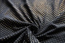 Defocused Blurred Golden Polka Dot Pattern On Black Folded Fabric As Background