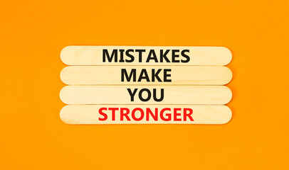 Wall Mural - Mistake make stronger symbol. Concept words Mistakes make you stronger on wooden stick. Beautiful orange table orange background. Business mistake make stronger concept. Copy space.