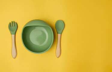 A set of children's silicone dishes. Baby feeding and nutrition concept. Top view, flat lay.