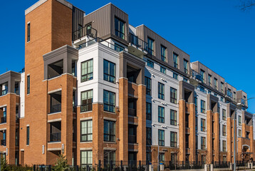 Wall Mural - Modern apartment buildings on a sunny day with a blue sky. Facade of a modern apartment building. New apartment building