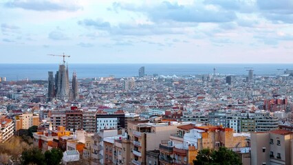 Wall Mural - Beautiful aerial timelapse view of the Barcelona city with a Sagrada Familia cathedral standing in the city center. 