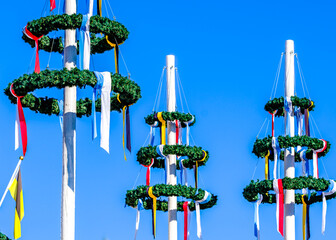 Wall Mural - typical bavarian maypole with wreath