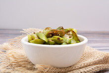 Grilled Okra, In A White Bowl On A Wooden Table, Focused, Front View