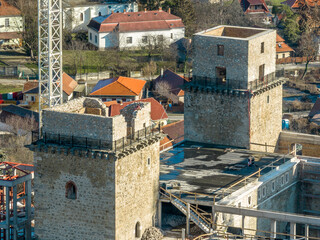 Poster - Closeup aerial view of two square towers being restored in medieval Diosgyor castle in Miskolc Hungary