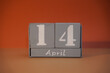 © Oksana - 14 April on wooden grey cubes. Calendar cube date 14 April. Concept of date. Copy space for text or event. Educational cubes. Wood blocks in box with date. Selective focus blurred background
