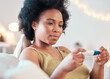 © T Mdlungu/peopleimages.com - Black woman, pregnancy test and confused, nervous and waiting for results on a sofa in her home. Pregnant, testing and female unsure, doubt and holding result, checking and reading in a living room