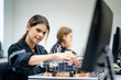 © FotoArtist - female engineer working on industrial machine in a laboratory.