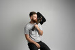 © Volodymyr - Portrait of handsome young bearded musician, guitar player with a acoustic guitar on a shoulder.